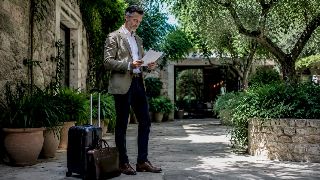 Traveler reviews private transfer details at airport arrival
