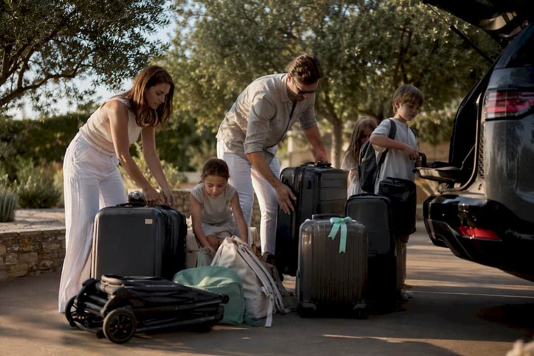 Family organizing luggage for private transfer